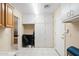 Storage room with white cabinets and folding chairs at 8958 W Rosemonte Dr, Peoria, AZ 85382