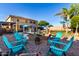 Spacious backyard featuring a pool, a covered patio and a fire pit area at 9569 W Redbird Rd, Peoria, AZ 85383