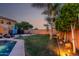 Spacious backyard featuring a pool, manicured lawn, outdoor seating, and thoughtful landscaping for serene outdoor living at 9569 W Redbird Rd, Peoria, AZ 85383