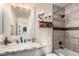 Stylish bathroom featuring a tiled shower and a vanity with granite countertop at 9569 W Redbird Rd, Peoria, AZ 85383