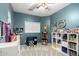 Fun room features an arcade game, Route 66 sign, and ample storage with shelving at 9569 W Redbird Rd, Peoria, AZ 85383