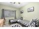 Bedroom featuring 2 twin beds with checkered bedding, a black and white rug, and gray curtains at 9569 W Redbird Rd, Peoria, AZ 85383