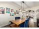 A dining room is furnished with a wooden table, blue velvet chairs, and framed photos at 9569 W Redbird Rd, Peoria, AZ 85383