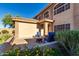 Charming front porch with comfortable seating, a fire pit, and blossoming flowers, framed by the home's architecture at 9569 W Redbird Rd, Peoria, AZ 85383