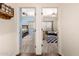 Hallway view showcasing two bedrooms with a ceiling fan in each one at 9569 W Redbird Rd, Peoria, AZ 85383