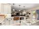 Open kitchen with granite counters, a copper sink, island, and views into the living area at 9569 W Redbird Rd, Peoria, AZ 85383