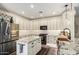 Bright kitchen features white cabinets, stainless steel appliances, granite counters, and an island at 9569 W Redbird Rd, Peoria, AZ 85383