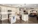 Spacious open concept kitchen featuring white cabinets, granite countertops, and stainless steel appliances at 9569 W Redbird Rd, Peoria, AZ 85383