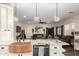 A granite countertop with an island in an open concept kitchen with an adjacent living area at 9569 W Redbird Rd, Peoria, AZ 85383