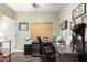 Comfortable office space with wood-look floors, a large desk, and a rolling office chair at 9569 W Redbird Rd, Peoria, AZ 85383