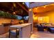 Outdoor kitchen and dining space, complete with bar seating and cozy lounge area for relaxation at 9569 W Redbird Rd, Peoria, AZ 85383
