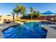 Refreshing pool area surrounded by lush landscaping and patio furniture at 9569 W Redbird Rd, Peoria, AZ 85383