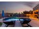 Beautiful backyard with pool, lounge chairs, covered patio, and outdoor kitchen for ultimate relaxation and entertainment at 9569 W Redbird Rd, Peoria, AZ 85383