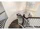 A winding staircase features hardwood steps, white risers and railing, and an overhead light fixture at 9569 W Redbird Rd, Peoria, AZ 85383