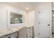 A vanity area features a granite countertop, white drawers, and a framed mirror with great lighting at 9569 W Redbird Rd, Peoria, AZ 85383