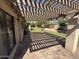 View of backyard with covered patio, pavers, and mature landscaping at 10190 N 106Th E St, Scottsdale, AZ 85258