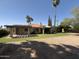 Rear exterior of home with large backyard, patio, and mature trees at 10190 N 106Th E St, Scottsdale, AZ 85258