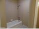 Full bath featuring tub, shower, and peach colored tiling at 10190 N 106Th E St, Scottsdale, AZ 85258