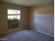 This carpeted bedroom features a bright window with green, leafy outdoor views at 10190 N 106Th E St, Scottsdale, AZ 85258