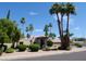 Charming single-story home featuring a well-maintained yard and mature palm trees at 10190 N 106Th E St, Scottsdale, AZ 85258