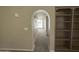 Inviting hallway with arched entryway and built-in bookshelves, leading to bright living spaces at 10190 N 106Th E St, Scottsdale, AZ 85258