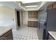 Functional kitchen with stainless steel fridge, tiled countertops, and ample cabinet space at 10190 N 106Th E St, Scottsdale, AZ 85258
