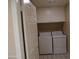Functional laundry room equipped with a washer, dryer, and ample storage cabinets at 10190 N 106Th E St, Scottsdale, AZ 85258