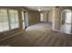 Well-lit living area featuring plush carpeting, neutral tones, and sliding glass door access at 10190 N 106Th E St, Scottsdale, AZ 85258
