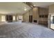 Spacious living room with vaulted ceilings, built-in shelves, and cozy fireplace at 10190 N 106Th E St, Scottsdale, AZ 85258