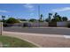 Neighborhood street view with palm trees and block wall fencing for privacy at 10190 N 106Th E St, Scottsdale, AZ 85258
