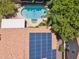 Aerial shot featuring a private backyard pool and spa, with solar panels installed on the home's roof and lush landscaping at 10367 E Wood Dr, Scottsdale, AZ 85260
