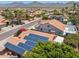 Aerial shot featuring solar panels and a view of a well-maintained residential neighborhood with mountain views in the distance at 10367 E Wood Dr, Scottsdale, AZ 85260