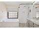 Bathroom with white tub, a shower, and granite countertops at 10367 E Wood Dr, Scottsdale, AZ 85260