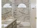 Bathroom featuring a granite countertop, sink, toilet, and marble-walled walk-in shower with grab bars at 10367 E Wood Dr, Scottsdale, AZ 85260