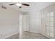 Empty bedroom with tile floors and a view of another room through French doors at 10367 E Wood Dr, Scottsdale, AZ 85260