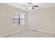 An empty bedroom with a window, tile floors, and a neutral color palette at 10367 E Wood Dr, Scottsdale, AZ 85260