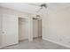 Bedroom featuring a ceiling fan, a closet with doors, and neutral-colored flooring and walls at 10367 E Wood Dr, Scottsdale, AZ 85260