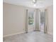 Bedroom with tiled floors and light streaming in from two windows with neutral-colored walls at 10367 E Wood Dr, Scottsdale, AZ 85260