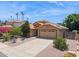 Single-story home featuring a well-manicured desert front yard and two-car garage at 10367 E Wood Dr, Scottsdale, AZ 85260