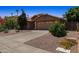 Front view of a home showcasing desert landscaping, a paved driveway, and a two car garage at 10367 E Wood Dr, Scottsdale, AZ 85260