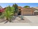 Inviting single-story home featuring a well-manicured desert front yard and two-car garage at 10367 E Wood Dr, Scottsdale, AZ 85260