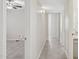 Bright hallway featuring tiled floors and neutral wall paint leading to bedrooms and bathroom at 10367 E Wood Dr, Scottsdale, AZ 85260