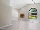 Spacious living room featuring large windows with vaulted ceiling and tiled floor at 10367 E Wood Dr, Scottsdale, AZ 85260