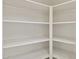 Spacious pantry with multiple rows of shelving to maximize storage space in this home at 10367 E Wood Dr, Scottsdale, AZ 85260
