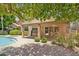 Enjoy outdoor living on the covered patio with brick accents, overlooking the pool and backyard at 10367 E Wood Dr, Scottsdale, AZ 85260