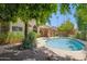 An inviting backyard pool surrounded by mature landscaping creates a private outdoor oasis at 10367 E Wood Dr, Scottsdale, AZ 85260
