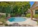 Landscaped backyard featuring a refreshing private pool surrounded by lush tropical greenery at 10367 E Wood Dr, Scottsdale, AZ 85260