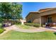 Scenic backyard with a built-in BBQ, patio area, mature trees, and well-maintained green spaces at 10850 W Avenida Del Rey --, Peoria, AZ 85383