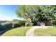 Lush backyard featuring manicured lawn, mature trees, grilling station, and landscaped features at 10850 W Avenida Del Rey --, Peoria, AZ 85383