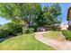A lush backyard boasts a brick walkway, green lawn, and mature landscaping, perfect for outdoor relaxation at 10850 W Avenida Del Rey --, Peoria, AZ 85383